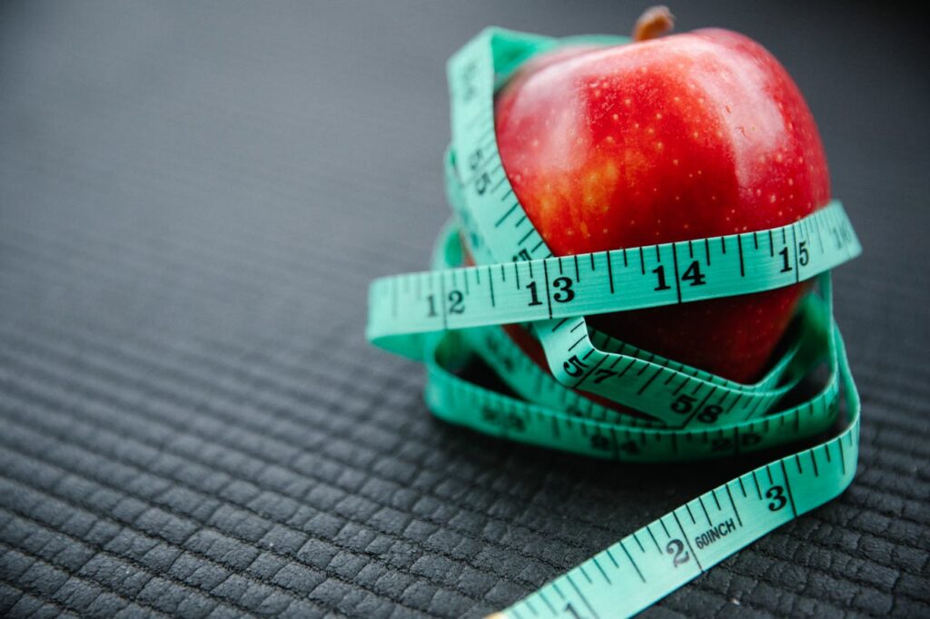 Measuring Tape Wrapped Around Red Apple